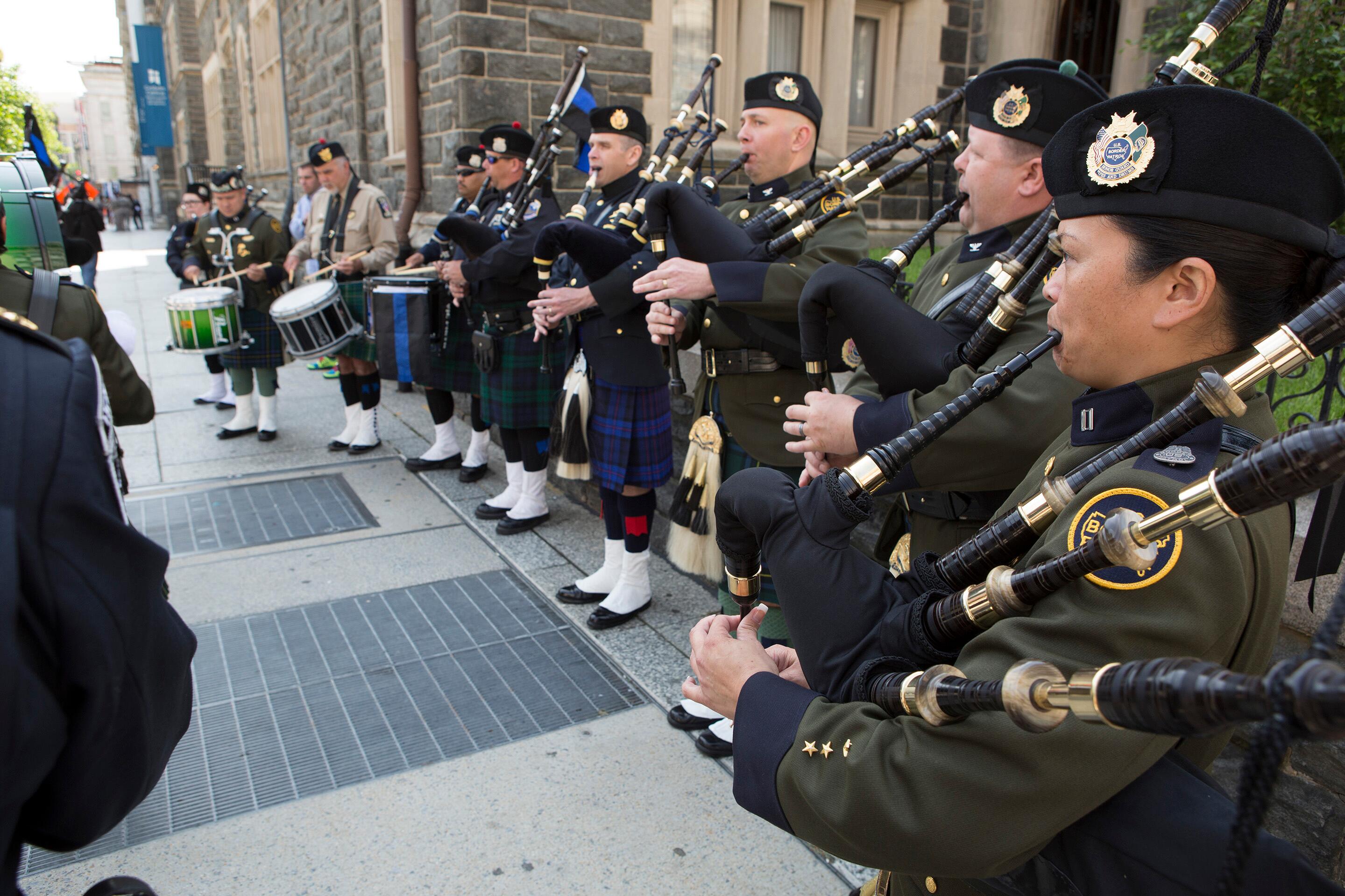 U.S. Customs and Border Protection Pipes and Drum Honor Guard members perform outside ceremony to honor fallen police and fire personnel, part of the 20th Annual Blue Mass in Washington, D.C. <em>(photo by James Tourtellotte)</em>
