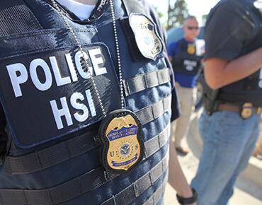 close up of an HSI Agents jacket and badge