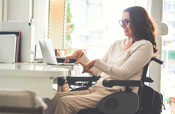 Woman in wheelchair working on computer