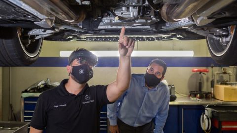 Mercedes-Benz USA technicians view the underside of a vehicle using HoloLens 2 headsets