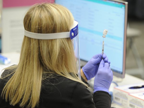 Jennifer Anderson-Fung, pharmacy manager at Thomas Hospitals, prepares a dose of the Pfizer-BioNTech COVID-19 vaccine on Thursday, December 17, 2020, at the hospital in Fairhope, Ala. (John Sharp/jsharp@al.com).