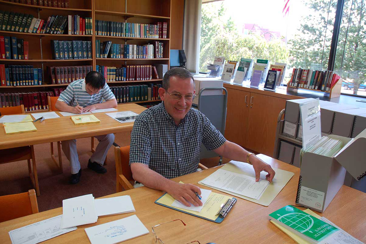 person sitting at desk inside library