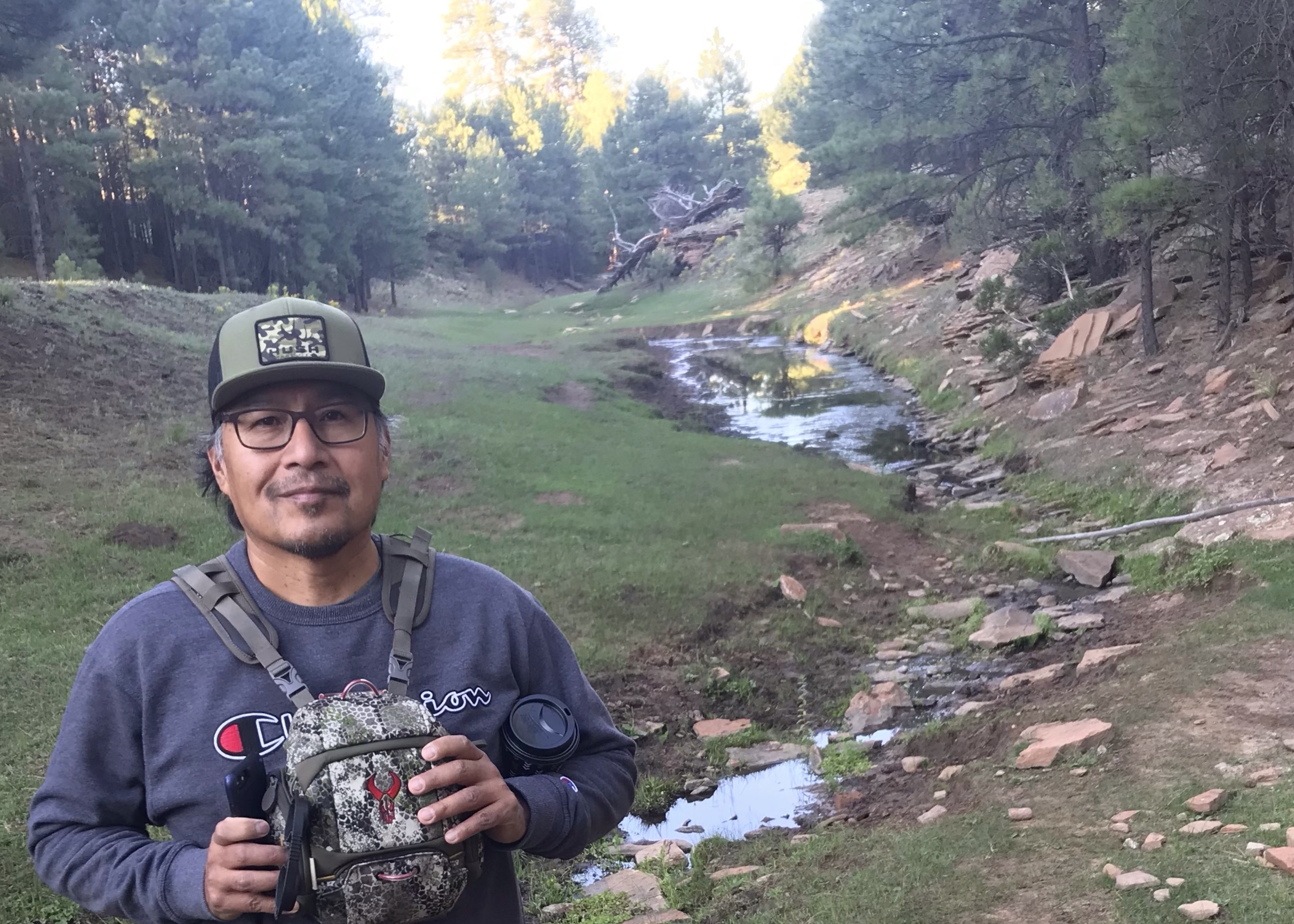 Michael Eldon Brown walking in a creek. USFWS.