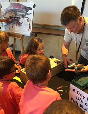 photo of children in a classroom learning about fish