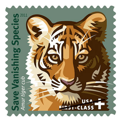 the stamp features a dramatic and colorful portrait drawing of an Amur tiger cub