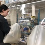 Scientist in laboratory working in anaerobic chamber