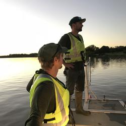 USGS scientists pause at sunset at the end of a long day collecting high-water measurements on the Llano River. 