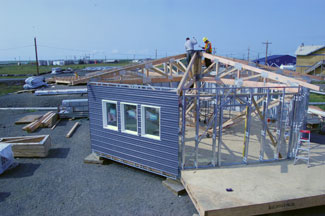 The work crew installing the roof truss