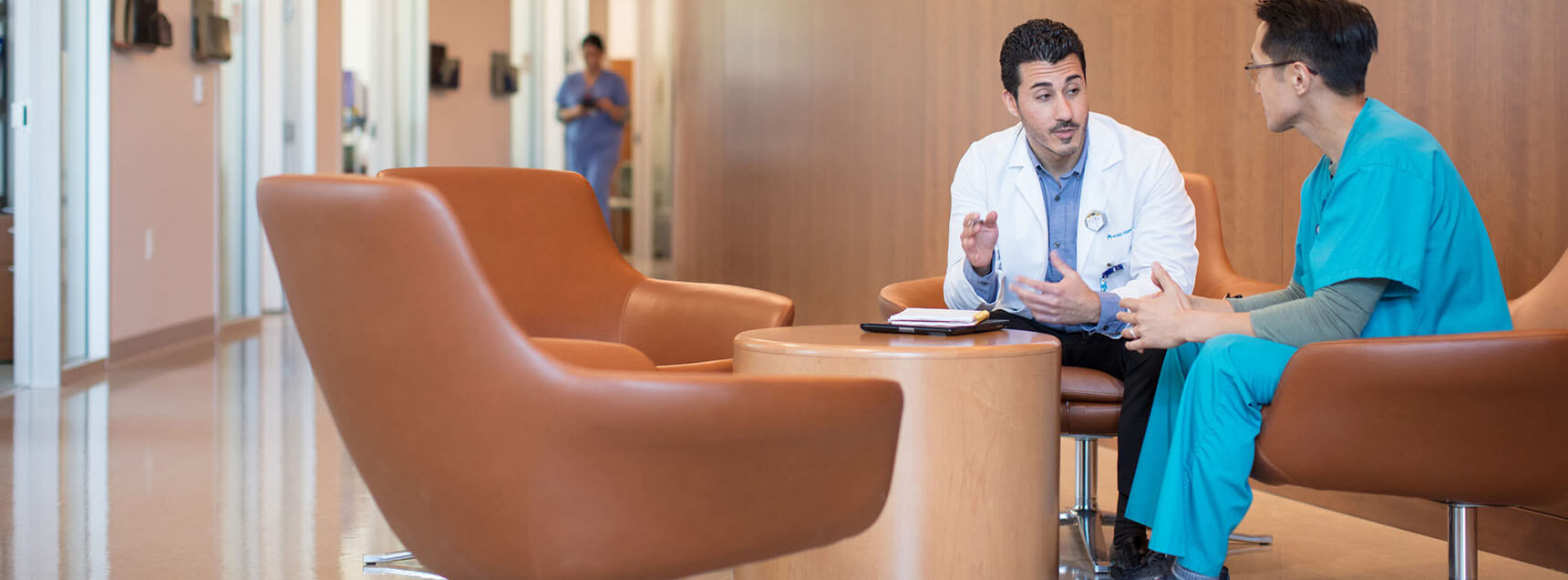 A medical professional speaking with a patient in a medical facility