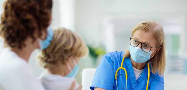 Doctor speaking to woman and child