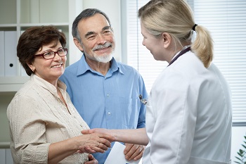 Photo of a man and a woman talking to a doctor