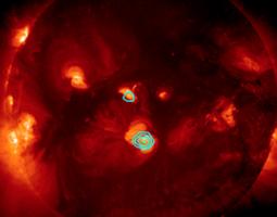 FOXSI’s observations of hard X-rays are shown in blue, superimposed over a soft  X-ray image of the Sun from the Hinode mission.