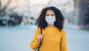 Woman wearing a mask.