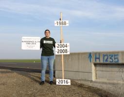 Photograph taken by Justin Brandt, USGS, of the National Geodetic Survey vertical control bench mark H1235 RESET in Merced Country, California.