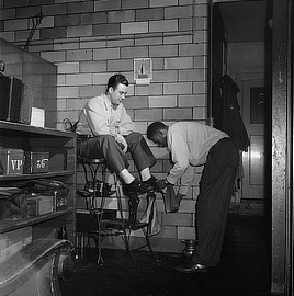 Pittsburgh, Pennsylvania. A Greyhound driver getting his shoes shined by a porter at the garage. Photo by Esther Bubley, 1943. Prints & Photographs Division