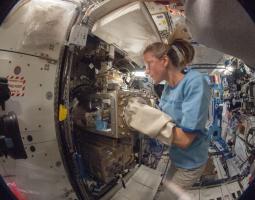 NASA astronaut Karen Nyberg, Expedition 36 flight engineer, as she conducts a session with the Advanced Colloids Experiment (ACE)-1 sample preparation at the Light Microscopy Module in the Fluids Integrated Rack / Fluids Combustion Facility.