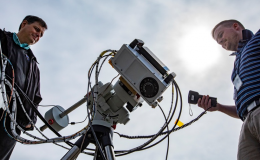 Photo of two men with the SAGE IV instrument hardware on a tripod