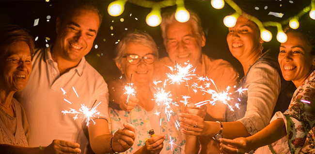 Group of diverse people holding sparklers