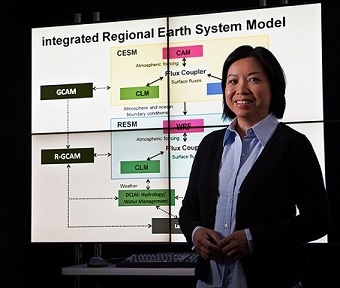 Researcher standing in front of a Powerpoint slide.