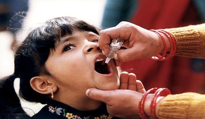 girl receiving oral polio vaccine