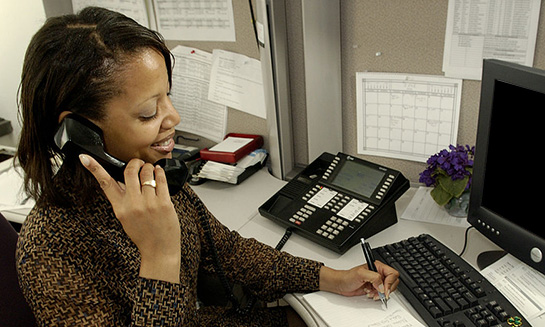 African American woman veteran on the phone at work.