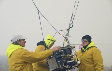 Scientists getting the air sampling system ready at the Flint Hills study site. 