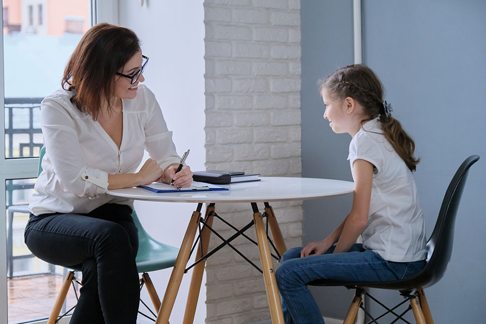 School counselor talking with 9 year old girl