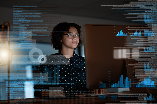 Woman looking at data and statistics on big screen computer