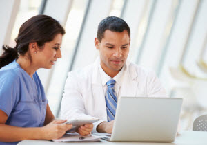 Man and woman looking at a computer