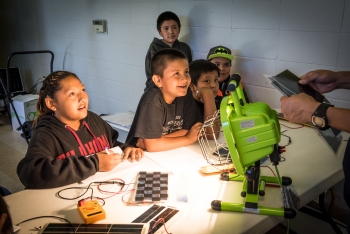 Photo of a group of children learning about solar panels