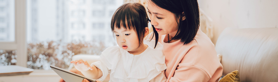 mom and daughter looking at tablet