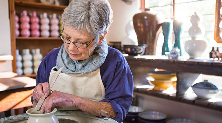 older woman making pottery
