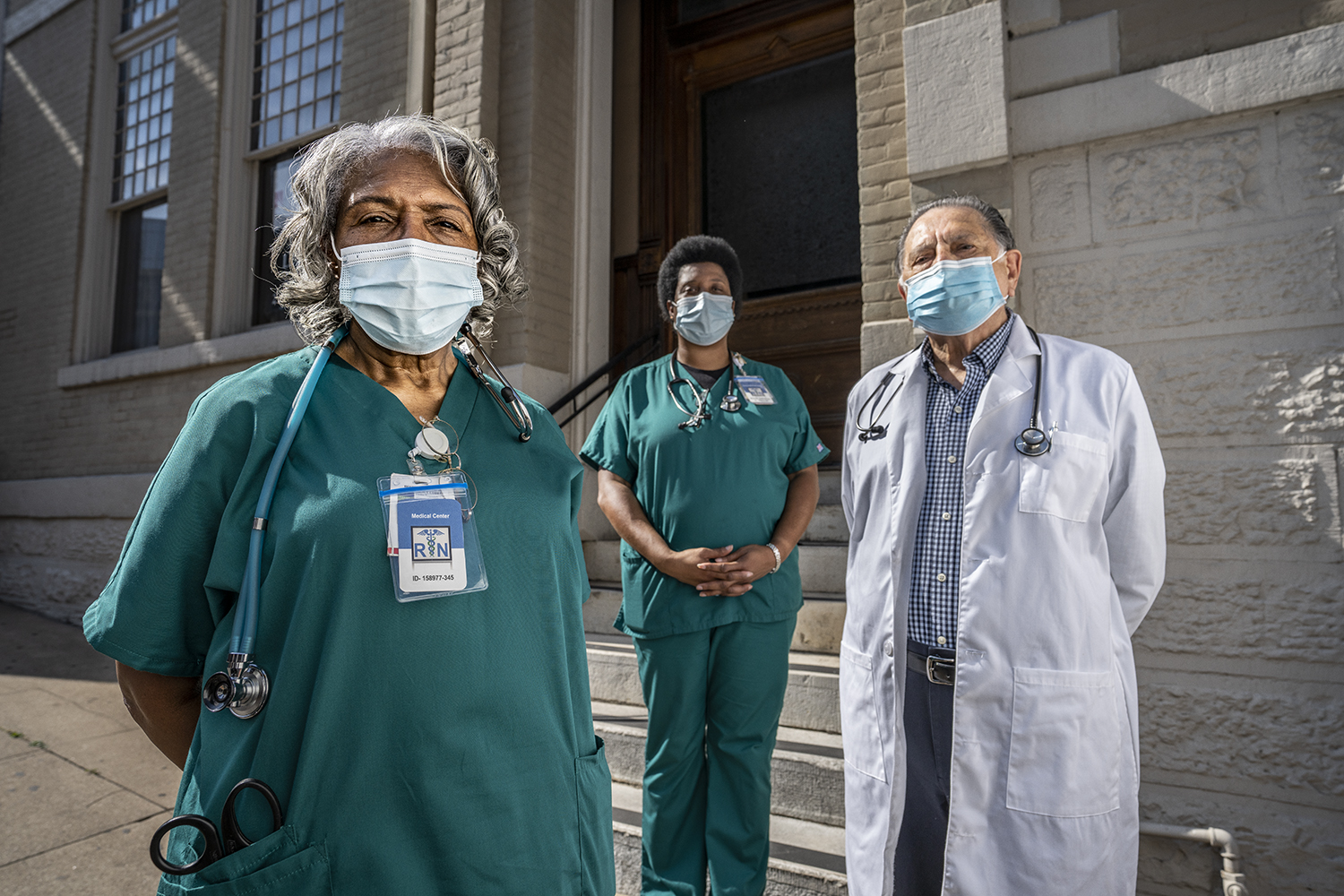 Image of two nurses and a doctor wearing masks.