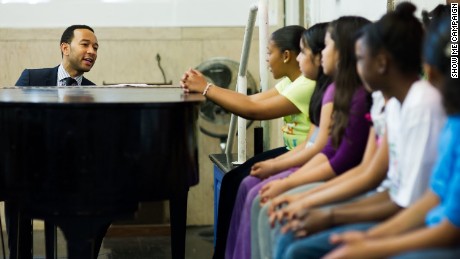 John Legend playing music with students 