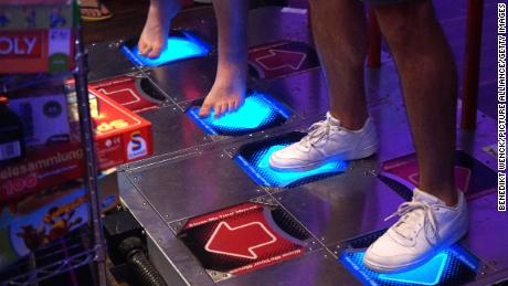 Visitors at the e-sport tournament &quot;Homestory Cup&quot; get ready to move by playing &quot;Dance Dance Revolution&quot; in the city of Krefeld, North Rhine-Westphalia, Germany, on June 29, 2019.