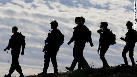 Members of the Israel Defense Forces (IDF) arrive at the site where a Palestinian house was demolished near Hebron in the West Bank on November 25, 2020.