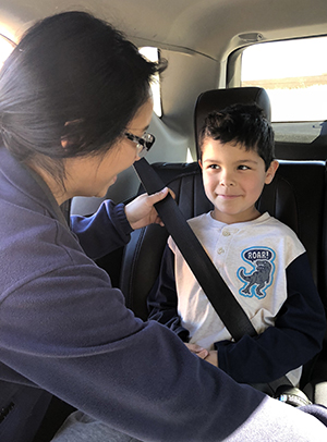 Rebekah Abangan assisting w booster seat install, Brandon Tsatoke Age 6