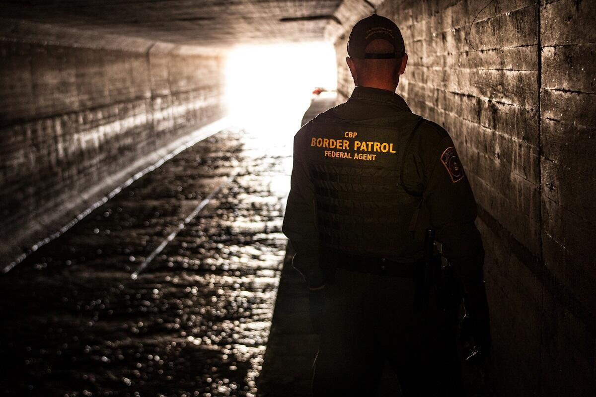 Border Patrol agent inspects a water drainage tunnel that spans from Nogales, Ariz. into Mexcio.<em> (photo by Josh Denmark)</em>