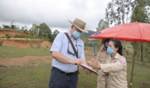 Ambassador Haymond speaks with a MAG survey team member. (Photo courtesy of U.S. Embassy Vientiane)