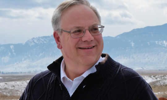 Secretary Bernhardt is a white mane with gray hair wearing glasses and standing outside.