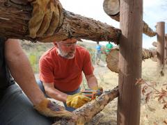 Volunteer builds a wood fence