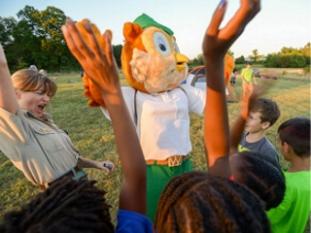 Woodsy Owl with park ranger and kids