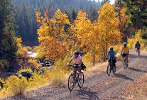 A family rides bikes on a dirt trail overlooking the Susan River.  Photo by Bob Wick, BLM.