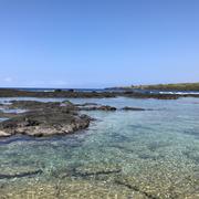 Crystal clear blue water shimmers in a lagoon.