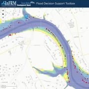 Zoomed in view of web map showing river, streets, structure outlines, and estimated flooding levels