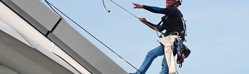 Construction worker hoisted in the air