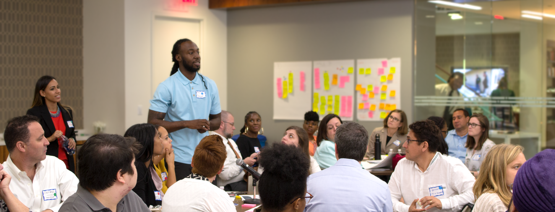 Man presenting to participants at a user engagement workshop hosted by The Opportunity Project