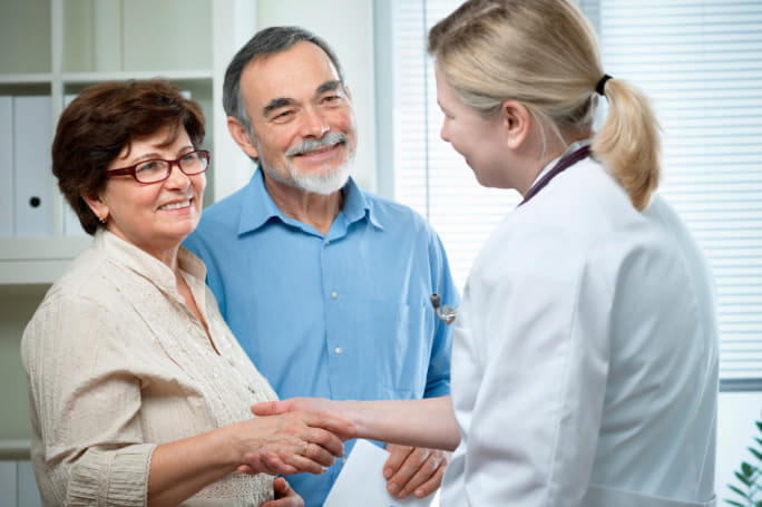 Photo of a man and a woman talking to a doctor