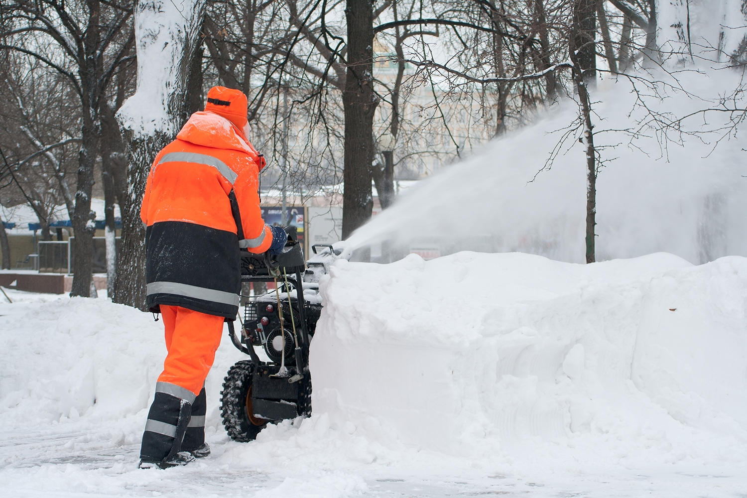 Image of worker clearing heavy snow with a snow-blower | photo credit: iStock