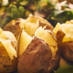 Cut open baked potatoes.